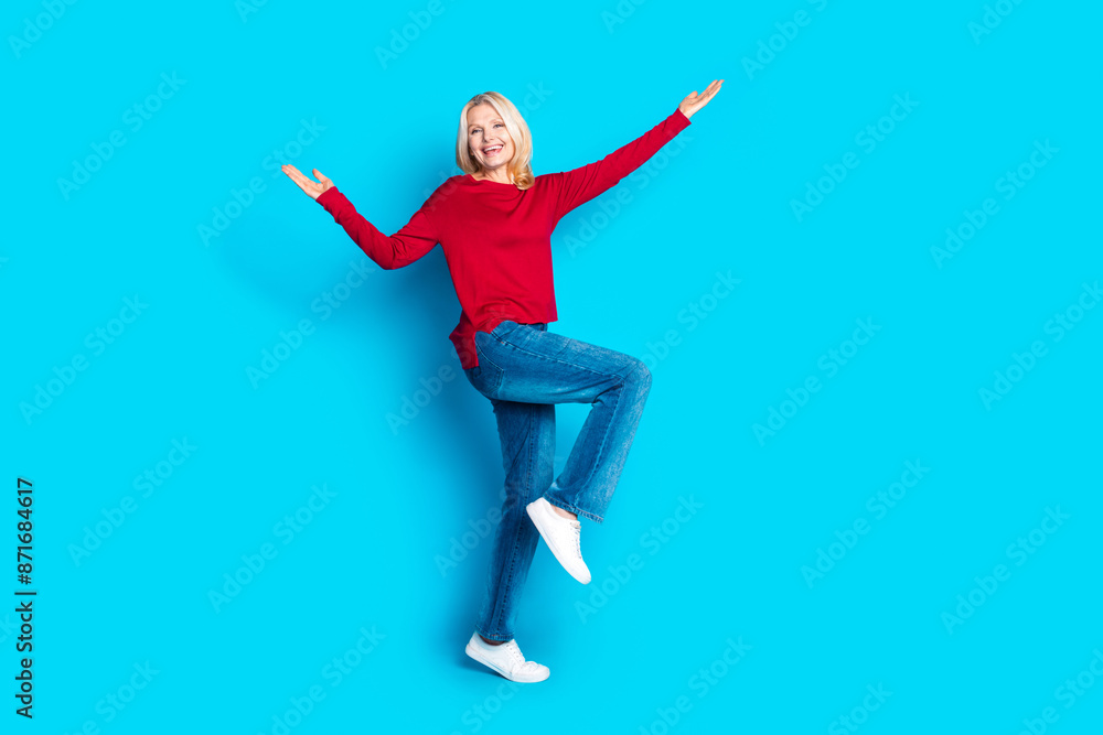 Fototapeta premium Full size photo of pretty senior female dancing have fun wear trendy red outfit isolated on blue color background