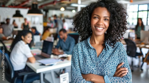 Confident Businesswoman With Curly Hair Smiling In Creative Office Space 