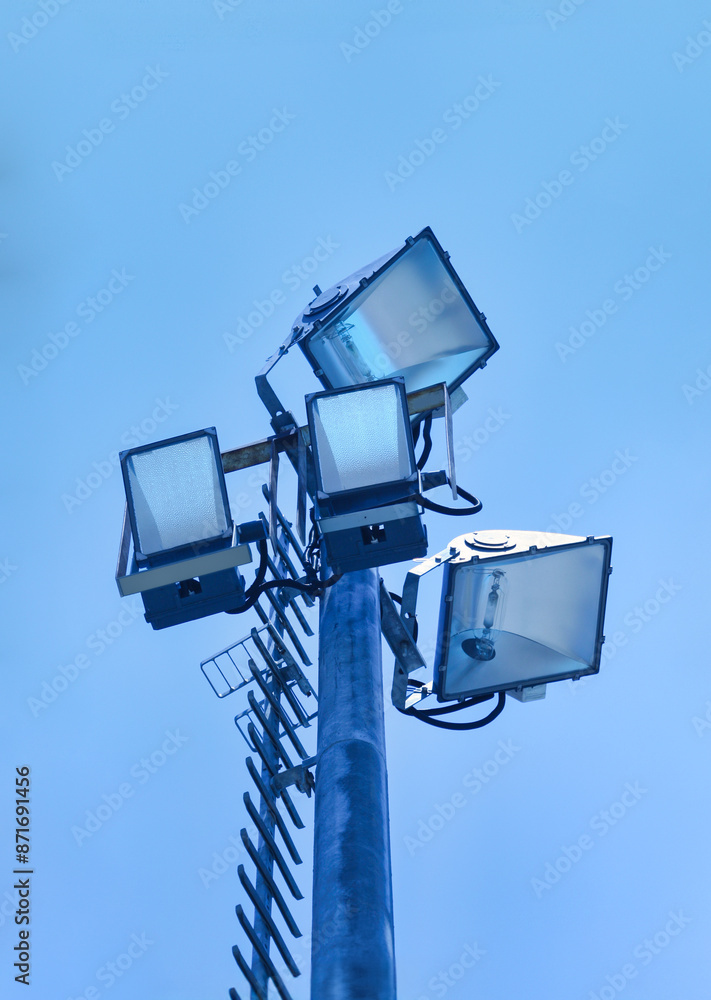 pole with halogen lights at an Olympic pool daytime pole with halogen lights at an Olympic pool daytime