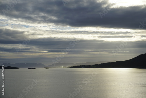 Summer in the fjords of Norway. A bright sunset and cirrus clouds illuminated by the setting sun. HDR light