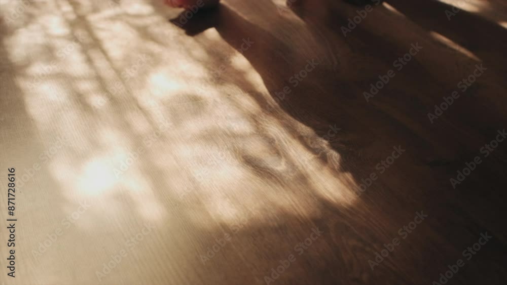 Unknown caring young mother and infant child. Childhood concept. Selective focus of little feet walking on floor. Close-up of baby learning to walk at home. Baby first steps Unknown caring young mother and infant child. Childhood concept. Selective focus of little feet walking on floor. Close-up of baby learning to walk at home. Baby first steps