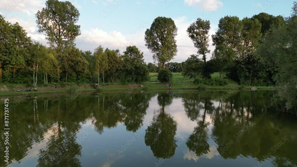Serene lake surrounded by greenery - drone view 4K Serene lake surrounded by greenery - drone view 4K