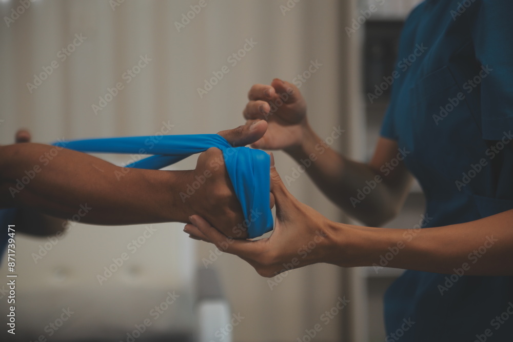 Professional physical therapist examines and cares for a young man in a physical therapy center, treating muscles and injuries of a man in a hospital. Professional physical therapist examines and cares for a young man in a physical therapy center, treating muscles and injuries of a man in a hospital.