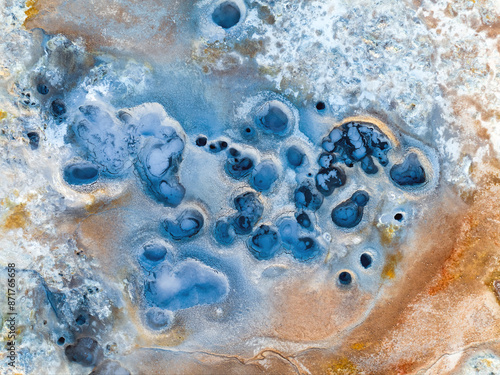 View from above, stunning aerial view of Námafjall Geothermal Area also known as Hverir with smoking fumaroles and boiling mud pots, surrounded by sulphur crystals of many different colours, Iceland.