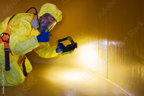 Employee inspecting a tank