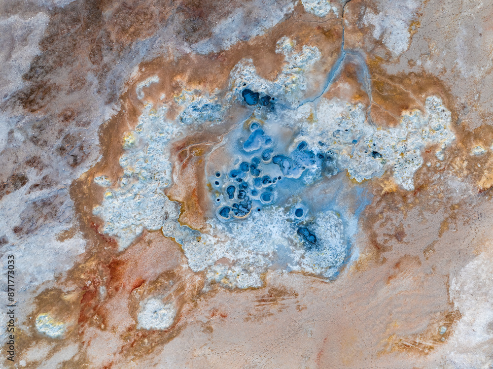 View from above, stunning aerial view of Námafjall Geothermal Area also known as Hverir with smoking fumaroles and boiling mud pots, surrounded by sulphur crystals of many different colours, Iceland.