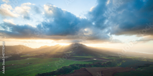 Aerial view of serene Waianae Sunset with majestic mountains, green fields, and picturesque sunset sky, Hawaii, United States. photo