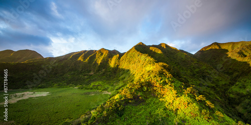 Aerial view of Kaau Crater surrounded by lush greenery and majestic mountains, Hawaii, United States. photo