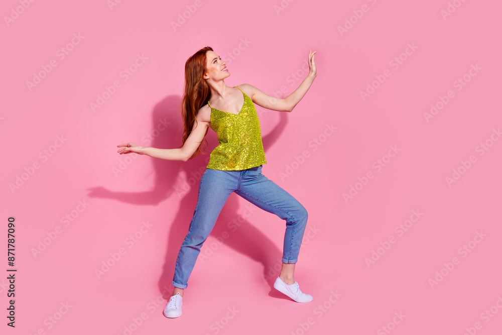 Full body portrait of nice young lady dance empty space wear shiny top isolated on pink color background Full body portrait of nice young lady dance empty space wear shiny top isolated on pink color background