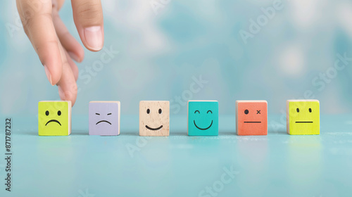 Emotions and States of Mind. Hand Arranging Emoticon Blocks photo