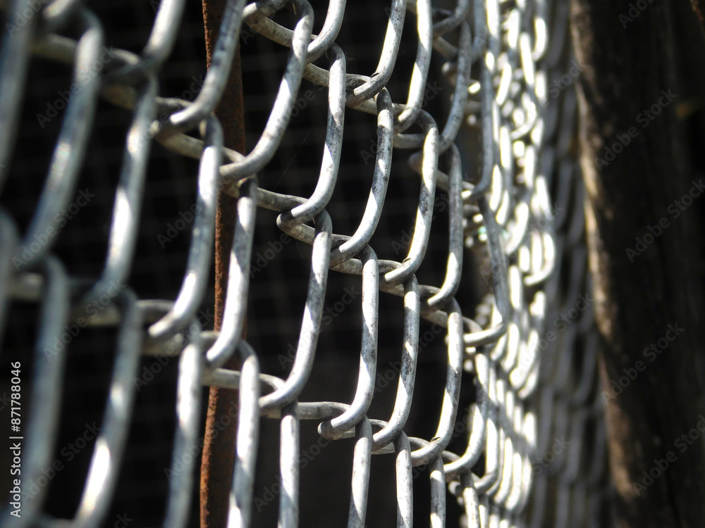 Detailed view of metal mesh highlights the complex interplay of structure and texture. Detailed view of metal mesh highlights the complex interplay of structure and texture.