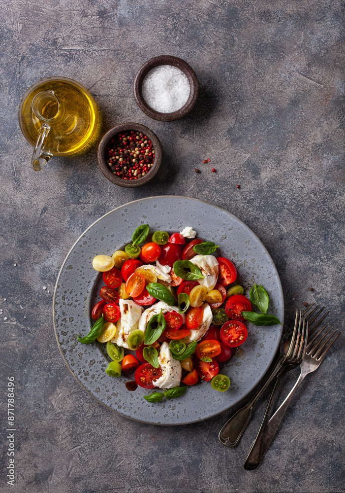 healthy colorful tomato mozzarella basil salad with balsamic vinegar dressing