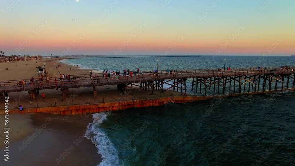 Aerial: Drone Lockdown Shot Of Men And Women On Fishing Pier At Beach During Sunset - Los Angeles, California Aerial: Drone Lockdown Shot Of Men And Women On Fishing Pier At Beach During Sunset - Los Angeles, California