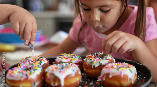 Kids decorating donuts with icing and sprinkles