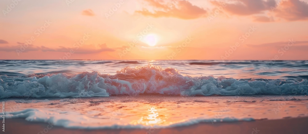 Fototapeta premium Sunset on the ocean shore with waves, creating a picturesque scene with a serene ambiance in the copy space image.