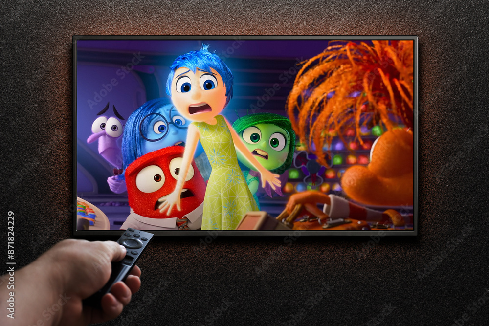 Inside Out 2 trailer or movie on TV screen. Man turns on TV with remote ...