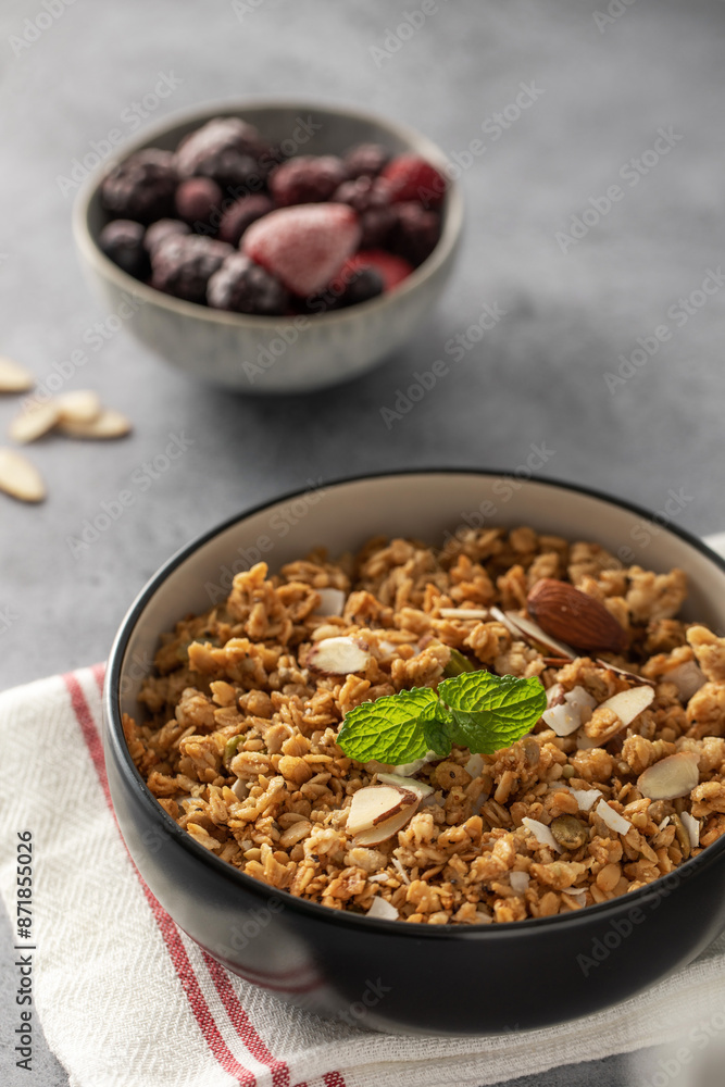 Crispy homemade granola with sliced almonds in a bowl. Healthy food Crispy homemade granola with sliced almonds in a bowl. Healthy food