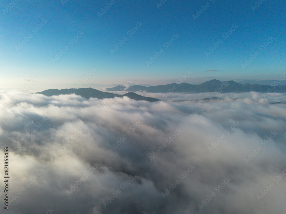 A high-angle landscape, dense fog, natural forest mountains covered in fog. A bright sky and beautiful landscape can be viewed from the sky with a drone. A high-angle landscape, dense fog, natural forest mountains covered in fog. A bright sky and beautiful landscape can be viewed from the sky with a drone.