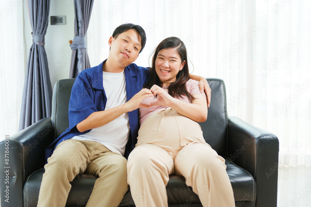 An Asian young husband gently embraces his pregnant wife at home, their love evident as they prepare for parenthood, cherishing the tender moments of expecting their first child together. An Asian young husband gently embraces his pregnant wife at home, their love evident as they prepare for parenthood, cherishing the tender moments of expecting their first child together.