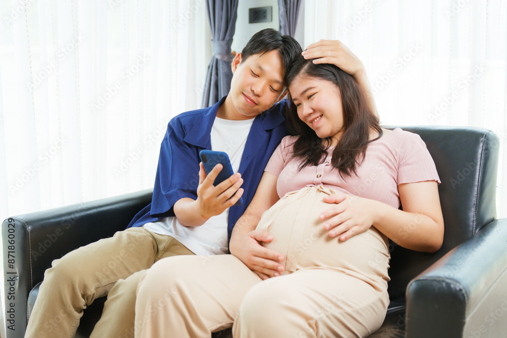 An Asian young husband gently embraces his pregnant wife at home, their love evident as they prepare for parenthood, cherishing the tender moments of expecting their first child together. An Asian young husband gently embraces his pregnant wife at home, their love evident as they prepare for parenthood, cherishing the tender moments of expecting their first child together.