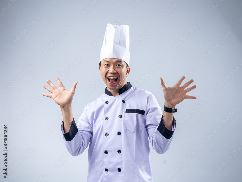 A smiling Asian male chef in a white uniform and hat holds up ten fingers, signifying the number ten, against a light blue background. The setting is professional and engaging A smiling Asian male chef in a white uniform and hat holds up ten fingers, signifying the number ten, against a light blue background. The setting is professional and engaging