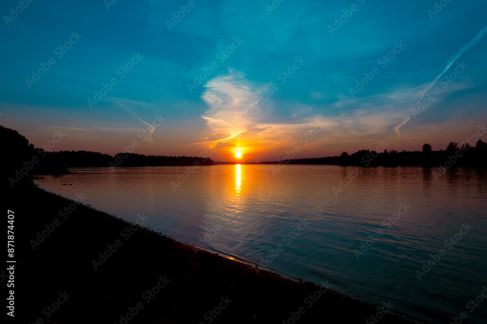 Golden sunset on the beach at neva river in saint-petersburg, russia. Tranquil scene. Nature background. Landscape. High quality photo