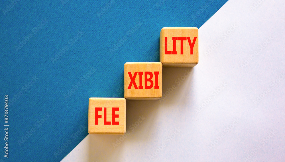 Obraz premium Flexibility symbol. Concept word Flexibility on beautiful wooden blocks. Beautiful white and blue background. Business flexibility concept. Copy space.