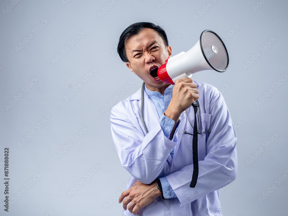 Asian male doctor in a white coat holding a megaphone and speaking enthusiastically. The plain background emphasizes the focus on the doctor's energetic announcement and the stethoscope Asian male doctor in a white coat holding a megaphone and speaking enthusiastically. The plain background emphasizes the focus on the doctor's energetic announcement and the stethoscope