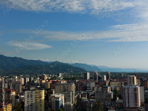 Charming view from the window of the scyscraper on the city, mountains, and the Black sea at sunset