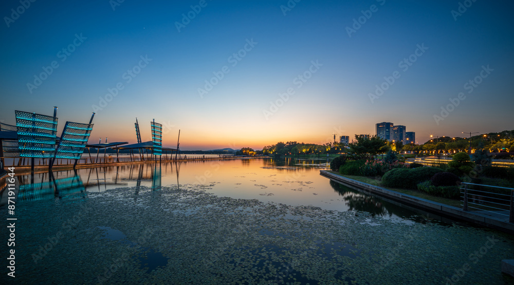 Fototapeta premium Serene Sunset Over Modern Waterfront
