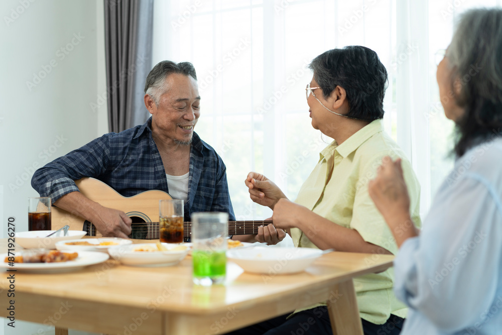 Three Senior friends bonding over music, singing and laughter in party Three Senior friends bonding over music, singing and laughter in party