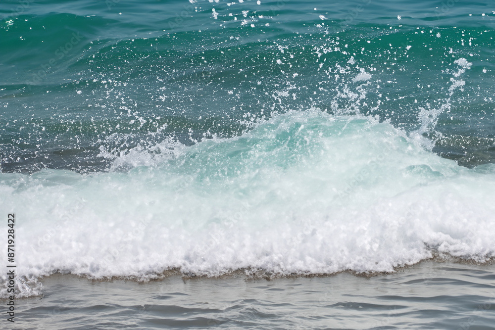 Obraz premium Waves splashing in the water. Wave ocean splash concept. White waves with splashes of water in the sea. A man splashes white water with waves in the lifestyle sea.