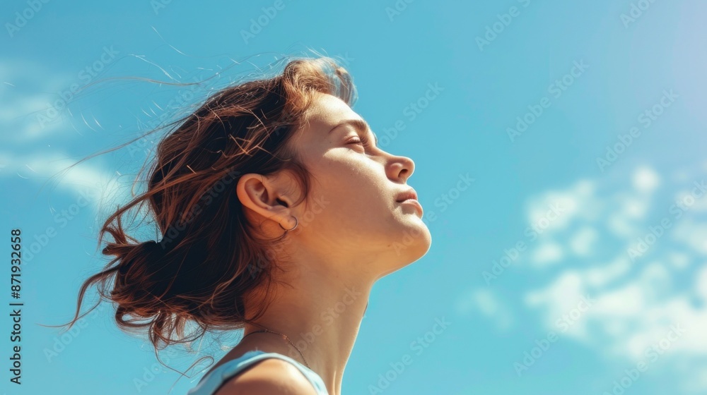 beautiful white woman with closed eyes looking up with a beautiful blue sky background beautiful white woman with closed eyes looking up with a beautiful blue sky background