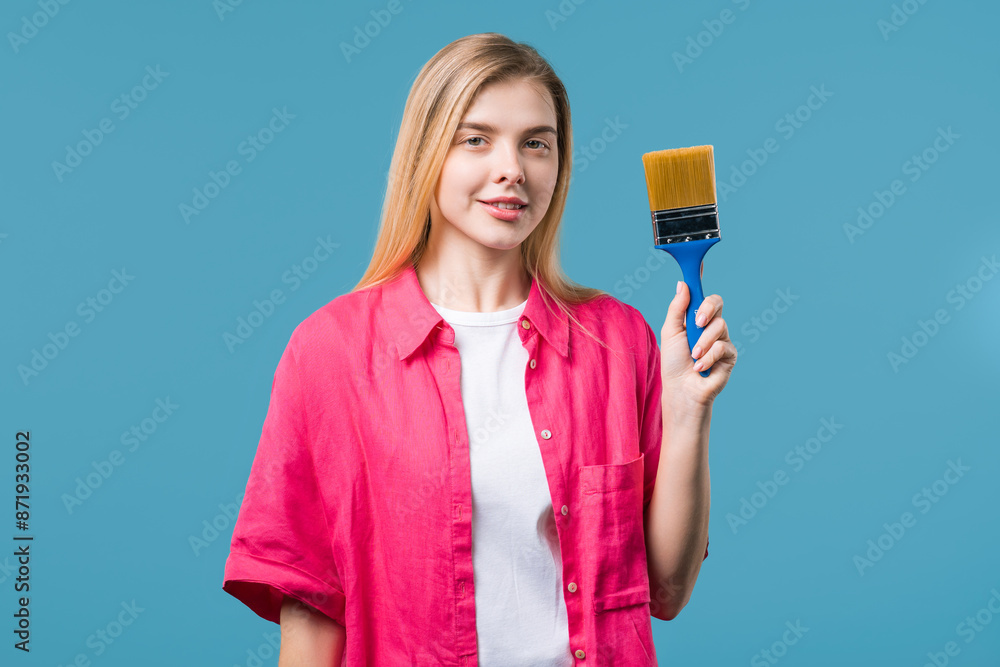 Young woman artist with brush on blue background. Creative person,fantasy,idea Young woman artist with brush on blue background. Creative person,fantasy,idea