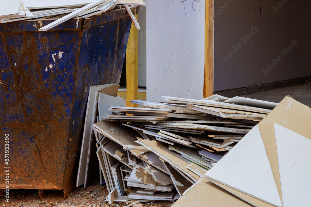 In course renovating house, drywall remains were disposed of in container of construction waste plasterboard In course renovating house, drywall remains were disposed of in container of construction waste plasterboard