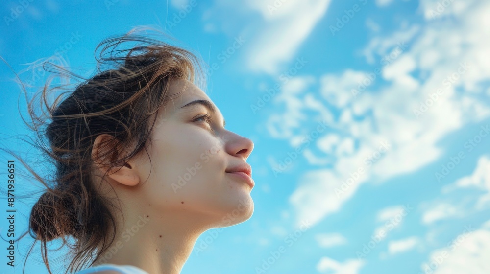 beautiful white woman with closed eyes looking up with a beautiful blue sky background beautiful white woman with closed eyes looking up with a beautiful blue sky background