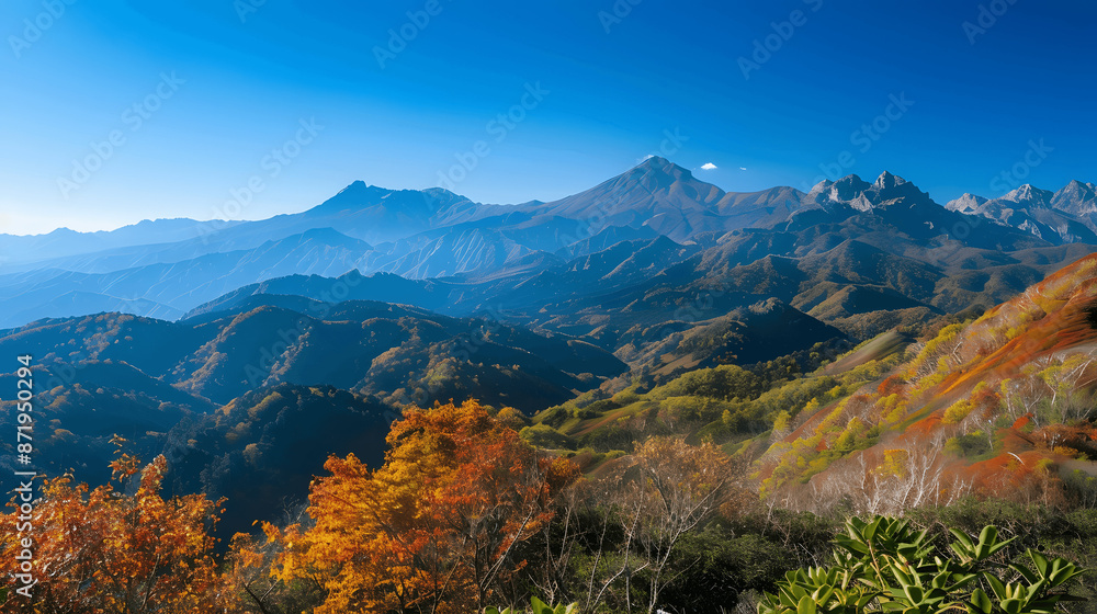 Picturesque mountain range with autumn colors and blue sky