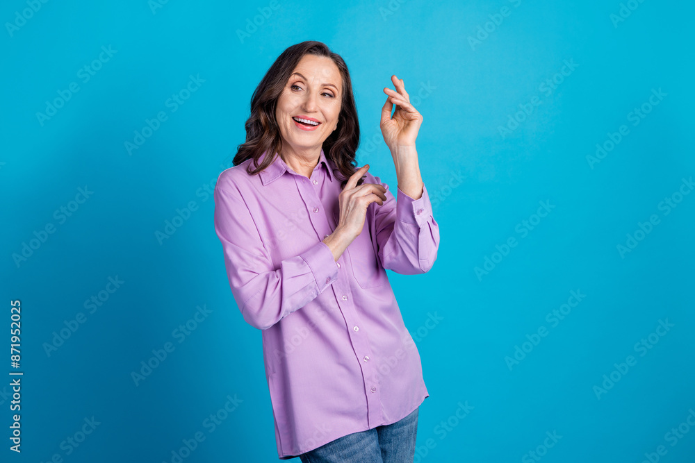 Photo of charming positive woman wear violet shirt dancing empty space isolated blue color background Photo of charming positive woman wear violet shirt dancing empty space isolated blue color background