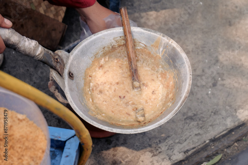 a typical food from betawi the province of DKI Jakarta, Indonesia made from eggs and sticky rice usually called kerak telor, being cooked in the traditional way photo