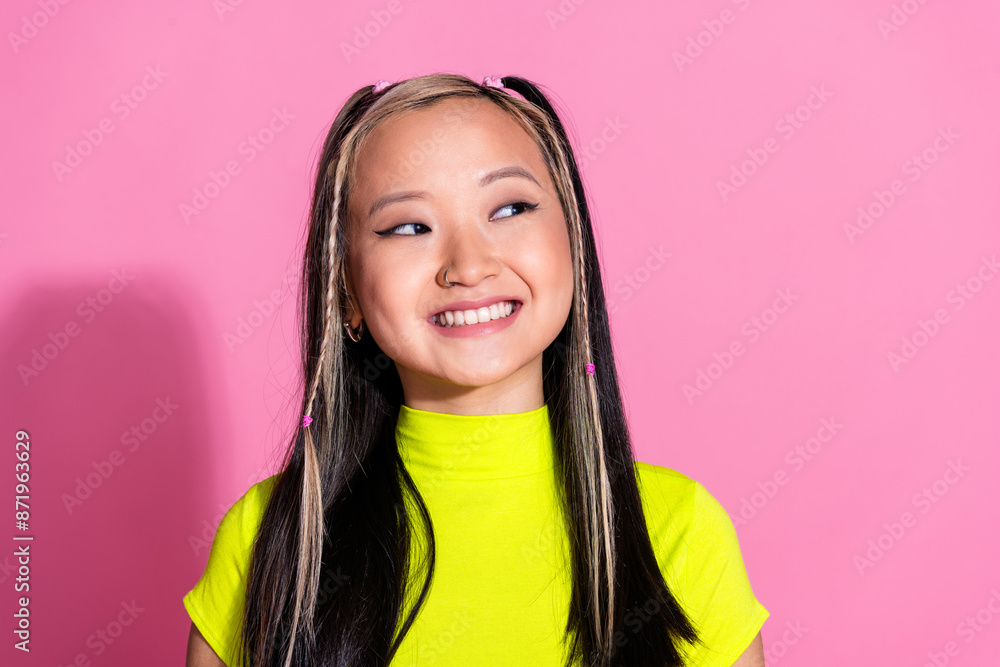 Photo of lovely positive girl with dyed hairstyle dressed yellow t-shirt look at offer empty space isolated on pink color background Photo of lovely positive girl with dyed hairstyle dressed yellow t-shirt look at offer empty space isolated on pink color background
