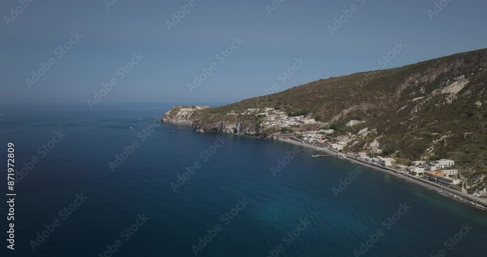 Aerial view of picturesque village on rocky coast with serene Mediterranean sea, Lipari Island, Italy. Aerial view of picturesque village on rocky coast with serene Mediterranean sea, Lipari Island, Italy.