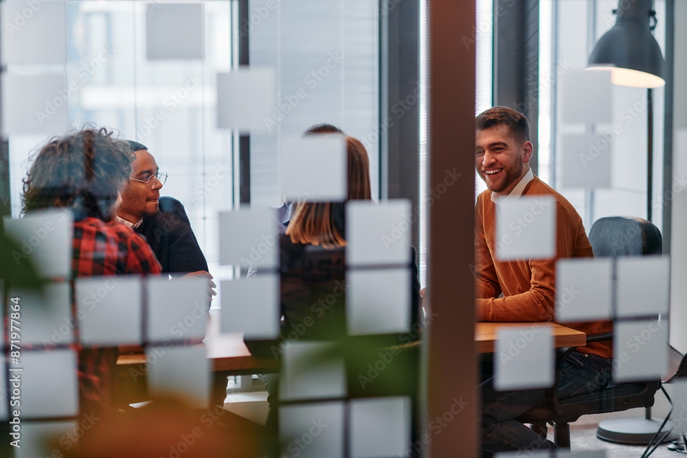 Fototapeta premium In a sleek glass office space, a team of business professionals engage in lively discussions and exchange strategic ideas, showcasing collaboration and innovation at the heart of modern corporate