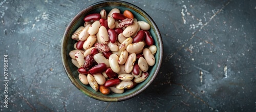 A bowl of uncooked white and red organic beans for a healthy eating concept, shot from above with room for text or images. photo