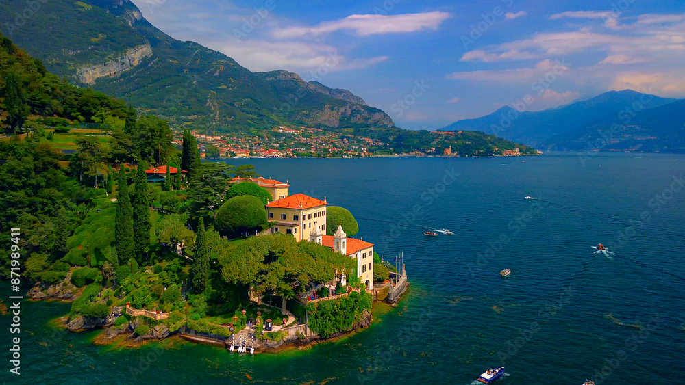 Fototapeta premium Aerial view of the luxury Villa Balbianello with terraced gardens, on the rocky wooded peninsula of Lavedo on Lake Como, panorama, picturesque residence. Green Planet. Nature. Lenno Italy 12.07.2024