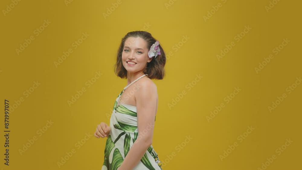 A woman in a pareo on a yellow background A woman in a pareo on a yellow background