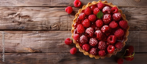 Wooden background sets stage for raspberry dessert, with ample copy space image.