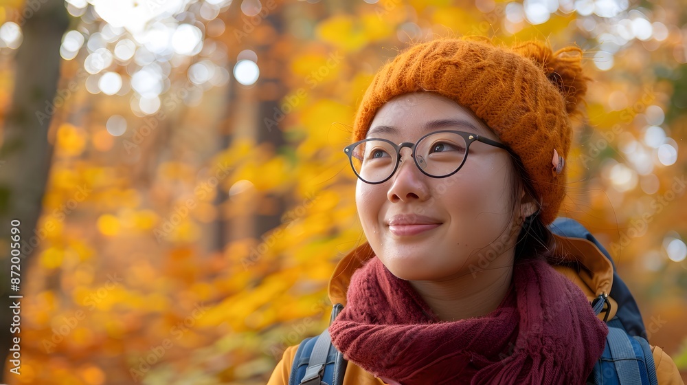 Young woman enjoying the autumn forest smiling with carefree joy. Young woman enjoying the autumn forest smiling with carefree joy.