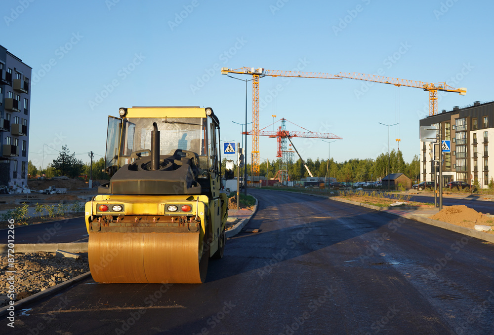 Asphalt road roller on road construction. Steamroller, Vibration roller compactor on press asphalt road. Steam Roller, Road Construction Equipment on construction. Vibration roller at asphalt pavement Asphalt road roller on road construction. Steamroller, Vibration roller compactor on press asphalt road. Steam Roller, Road Construction Equipment on construction. Vibration roller at asphalt pavement