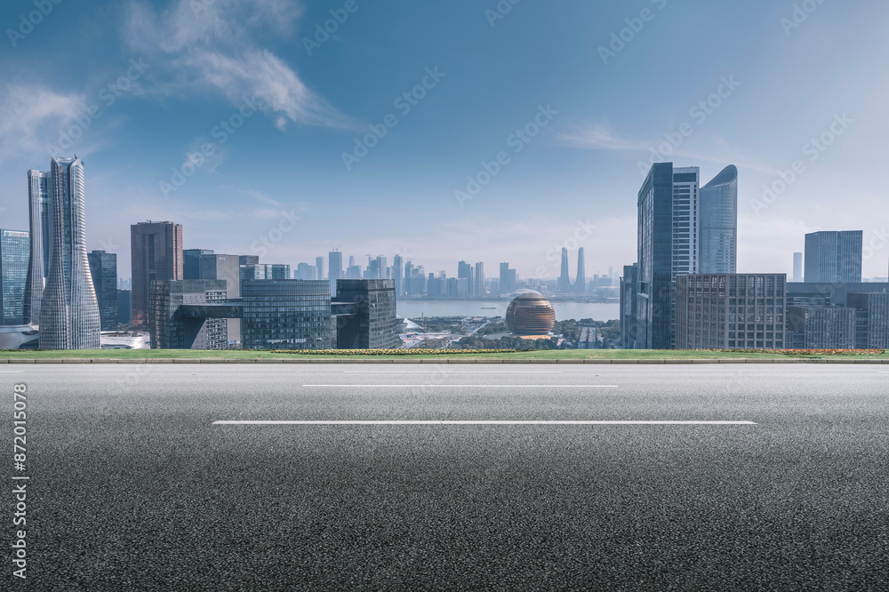 Modern Cityscape with Empty Road in Foreground Modern Cityscape with Empty Road in Foreground