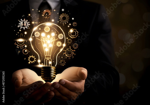 A businessman holding a light bulb with virtual business strategy icons for effective work planning leads to business success. Business development concept design
